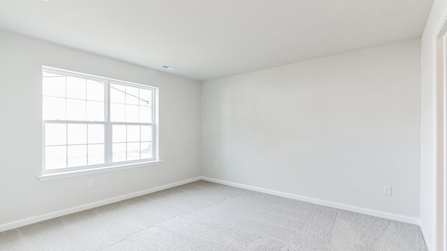 empty room featuring carpet flooring and a wealth of natural light