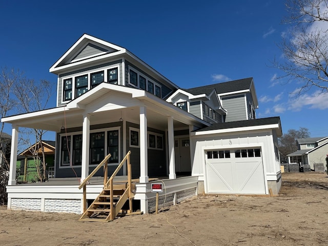 view of front of property featuring a porch, a garage, and board and batten siding