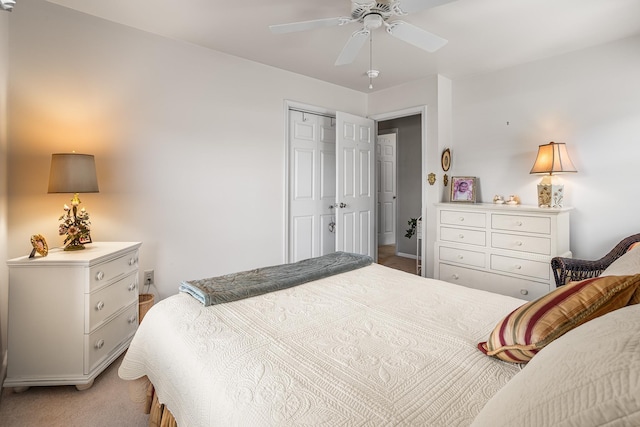 bedroom featuring a ceiling fan, light carpet, and a closet
