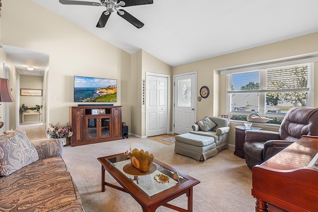 living area with a ceiling fan, baseboards, light carpet, and attic access