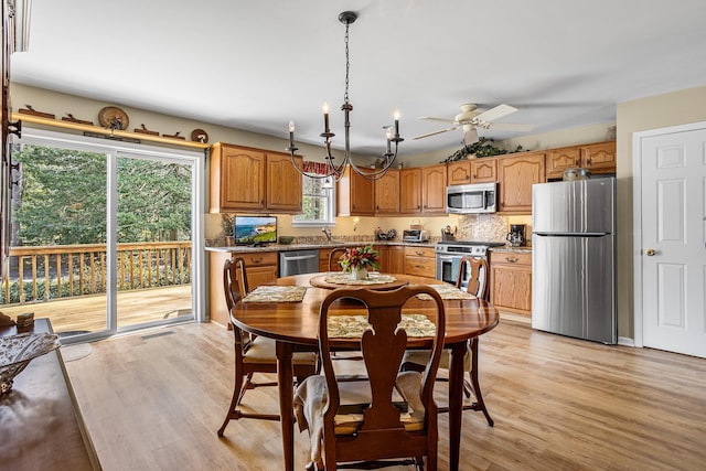 dining space featuring a ceiling fan and light wood-style flooring