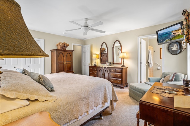 bedroom featuring light colored carpet and a ceiling fan