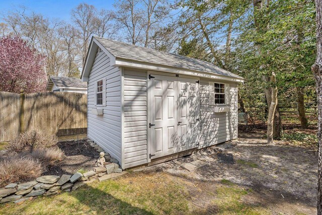 view of shed with fence