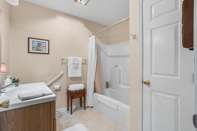 full bath with vanity, tile patterned floors, baseboards, and shower / bathtub combination with curtain