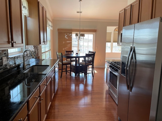29 Falkirk Dr, Rio Grande, NJ 08242 - kitchen with ornamental molding, a chandelier, dark wood-style floors, stainless steel appliances, and a sink