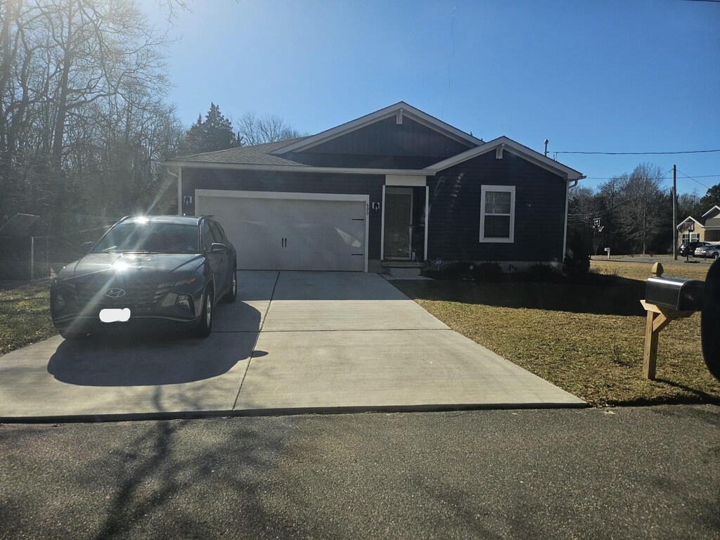 ranch-style home with an attached garage and driveway