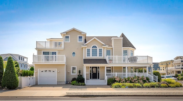 view of front of home featuring a garage and a balcony