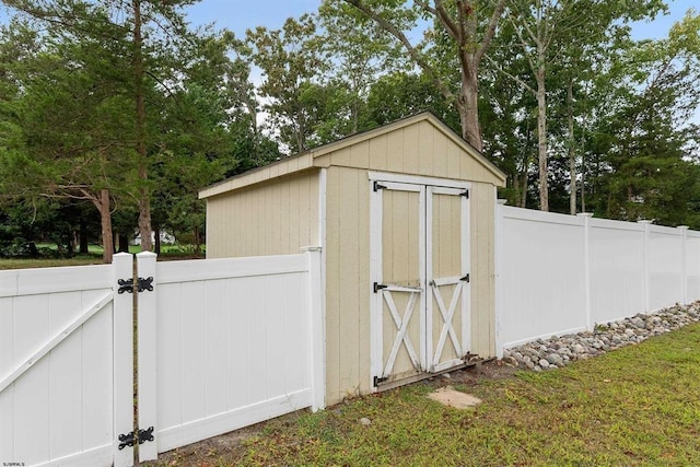 view of shed with a gate and fence