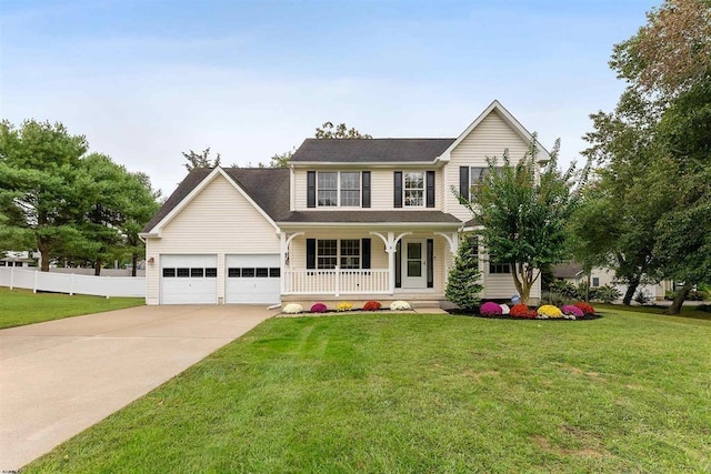 view of front facade featuring a front lawn, fence, covered porch, and driveway