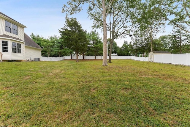 view of yard with cooling unit, an outdoor structure, a fenced backyard, and a storage shed