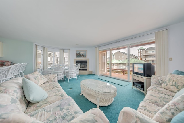 living area with carpet flooring and a glass covered fireplace