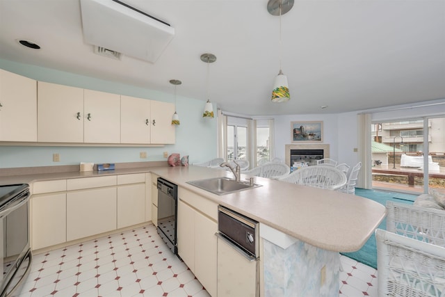 kitchen with a peninsula, light floors, electric stove, a sink, and dishwasher