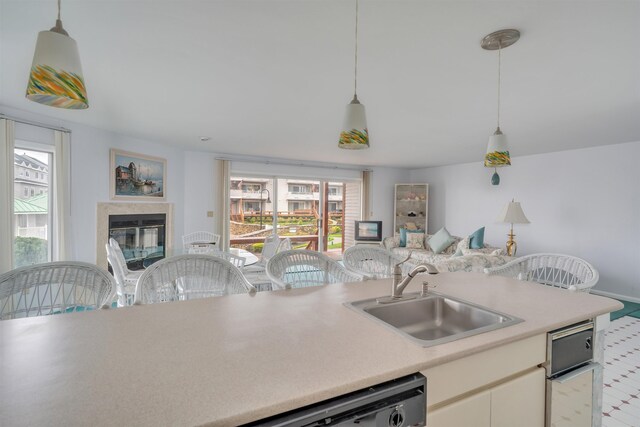 902 Ocean Dr Unit 301, Lower Township, NJ 08204 - kitchen featuring a sink, a healthy amount of sunlight, open floor plan, and light countertops