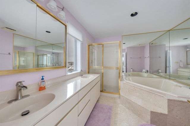 bathroom featuring double vanity, a sink, a garden tub, and a shower stall