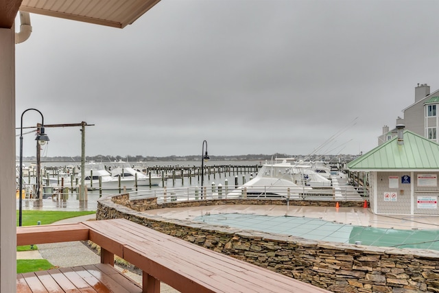 exterior space featuring a water view and a dock