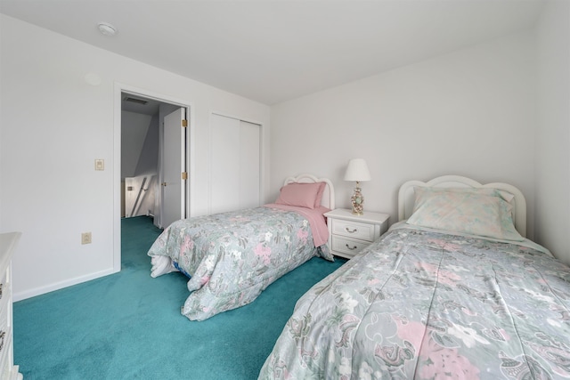 carpeted bedroom with baseboards and a closet