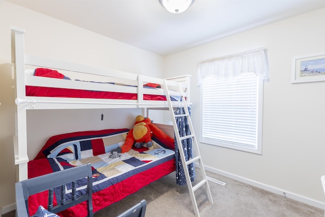 carpeted bedroom featuring baseboards