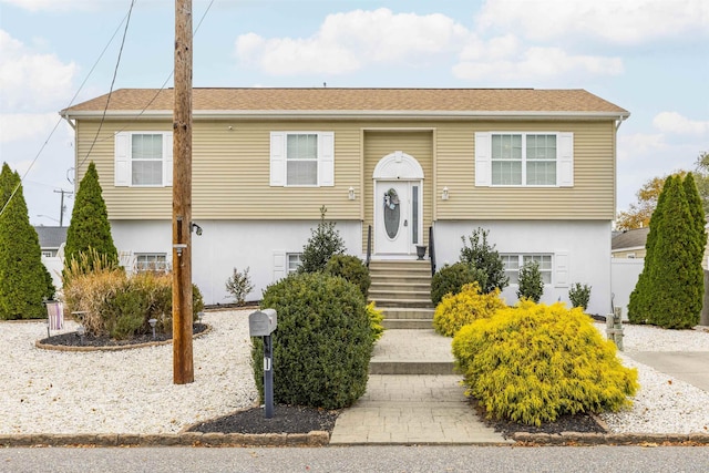 bi-level home featuring stucco siding