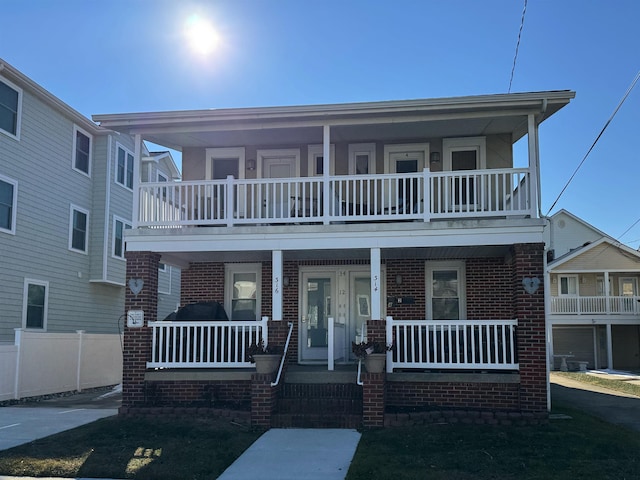 view of front of house with covered porch and brick siding