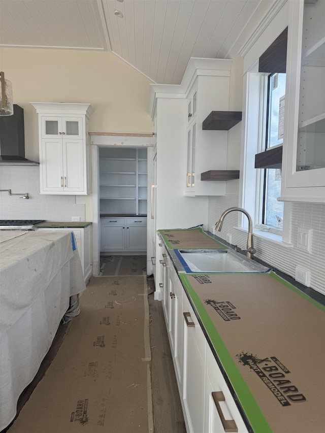 281 7th St, Avalon, NJ 08202 - kitchen featuring wall chimney range hood, wood ceiling, backsplash, white cabinetry, and vaulted ceiling
