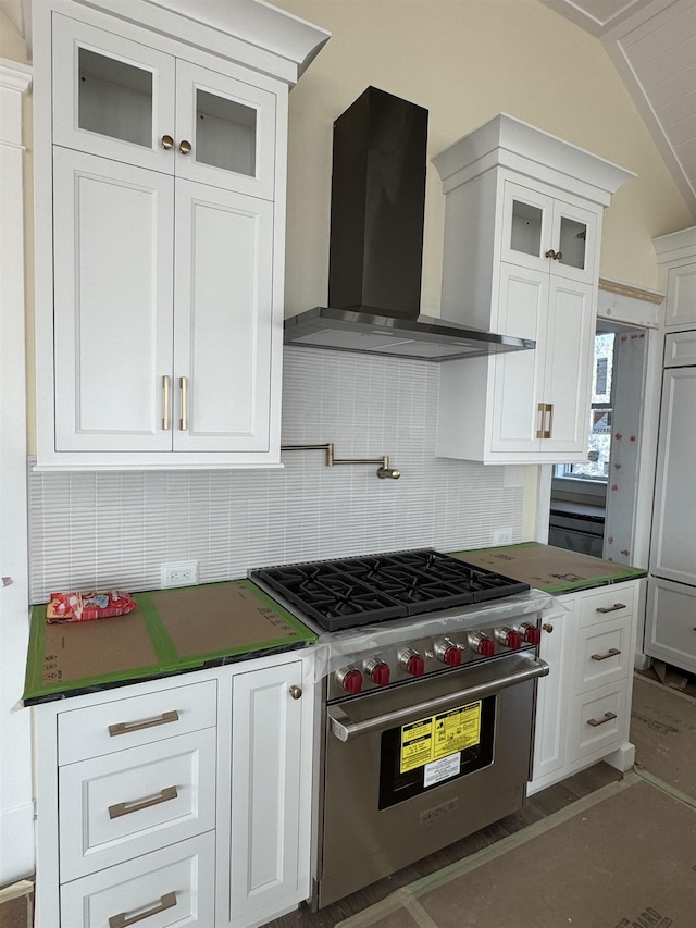 281 7th St, Avalon, NJ 08202 - kitchen with wall chimney range hood, premium range, backsplash, white cabinetry, and lofted ceiling