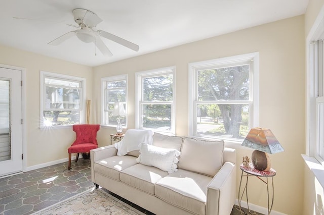 sunroom / solarium with ceiling fan and a healthy amount of sunlight