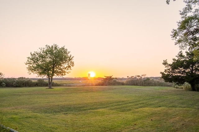 surrounding community with a yard and a rural view