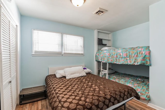 bedroom featuring hardwood / wood-style floors and a closet