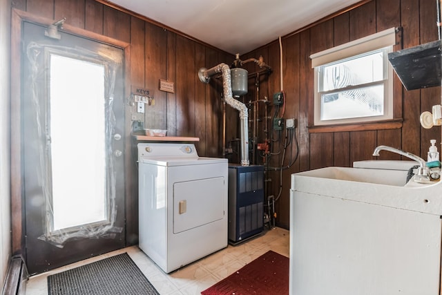 laundry room with washer / clothes dryer, wood walls, and sink