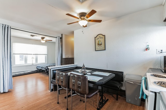 dining area featuring ceiling fan and wood-type flooring