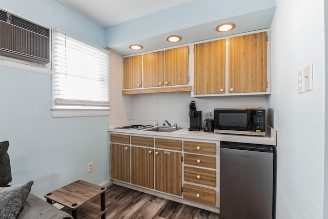 kitchen featuring refrigerator, dark hardwood / wood-style flooring, an AC wall unit, and sink