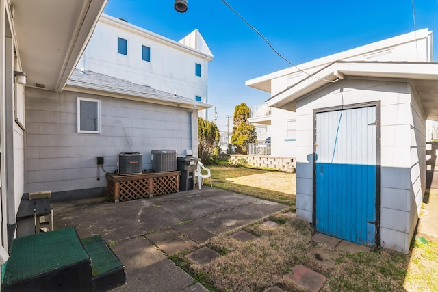 exterior space with central AC unit and a storage unit