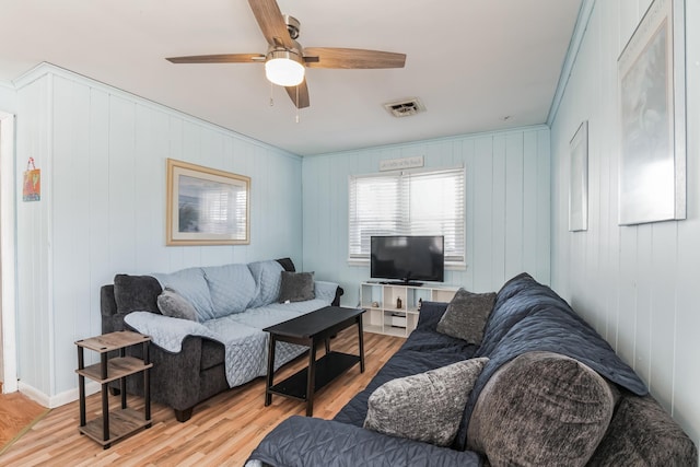 living room featuring ceiling fan and light hardwood / wood-style floors