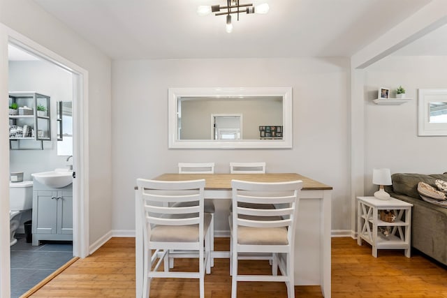 2205 New Jersey Ave Unit 1, North Wildwood, NJ 08260 - dining area with light wood-style flooring and a chandelier