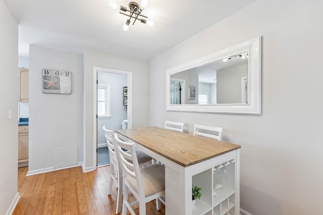 2205 New Jersey Ave Unit 1, North Wildwood, NJ 08260 - dining room with light wood finished floors and a chandelier