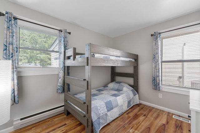 123 Broadway, Villas, NJ 08251 - bedroom featuring baseboard heating, wood finished floors, and baseboards