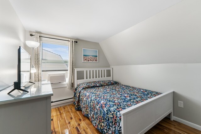 123 Broadway, Villas, NJ 08251 - bedroom with a baseboard heating unit, wood finished floors, cooling unit, lofted ceiling, and baseboards