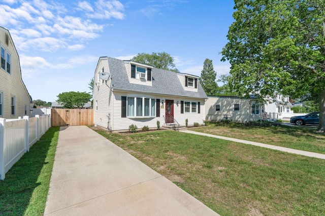 123 Broadway, Villas, NJ 08251 - colonial inspired home with concrete driveway, a shingled roof, and a gate