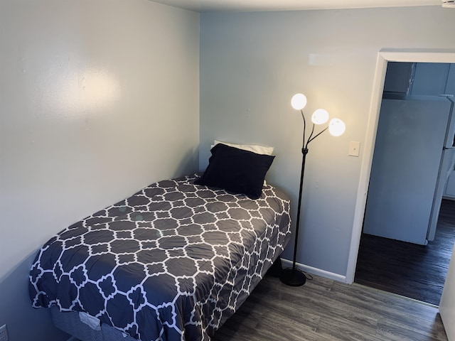 bedroom with dark wood-type flooring