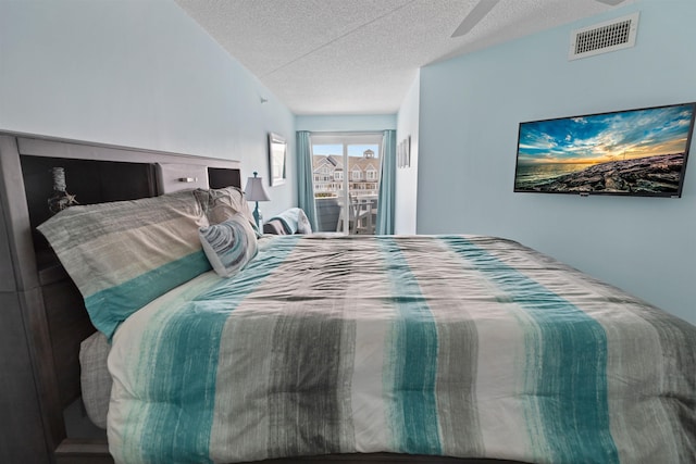 bedroom with a textured ceiling and visible vents