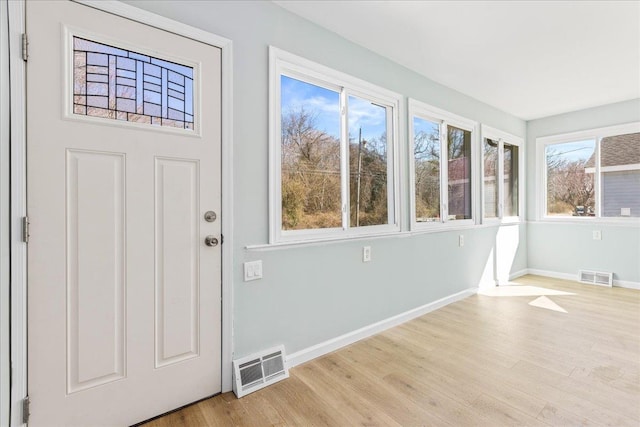 foyer with visible vents, baseboards, and wood finished floors