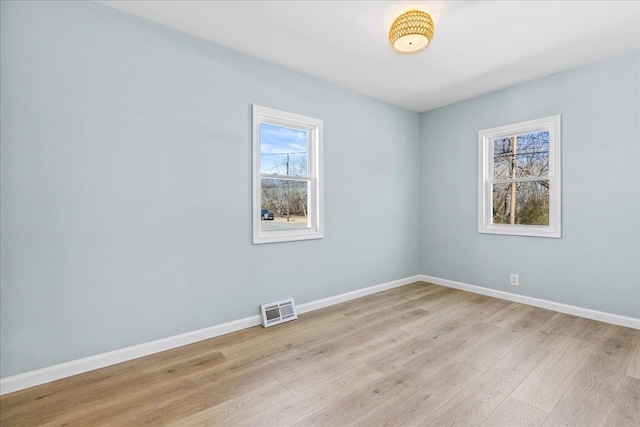 unfurnished room with visible vents, baseboards, and light wood-style floors