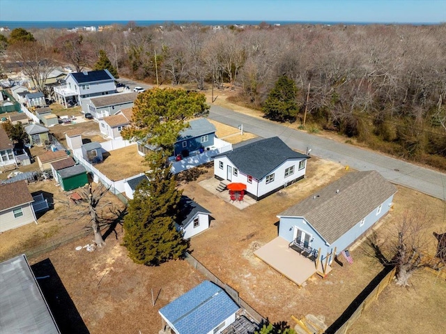 drone / aerial view with a forest view and a residential view