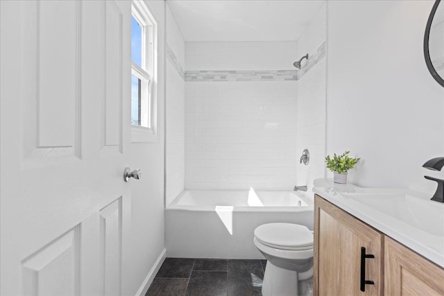 bathroom featuring tile patterned floors, toilet, vanity, baseboards, and shower / bathtub combination