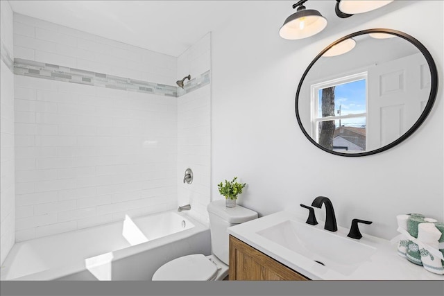 bathroom featuring vanity, shower / bathing tub combination, and toilet