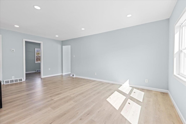 empty room with recessed lighting, light wood-style floors, visible vents, and baseboards