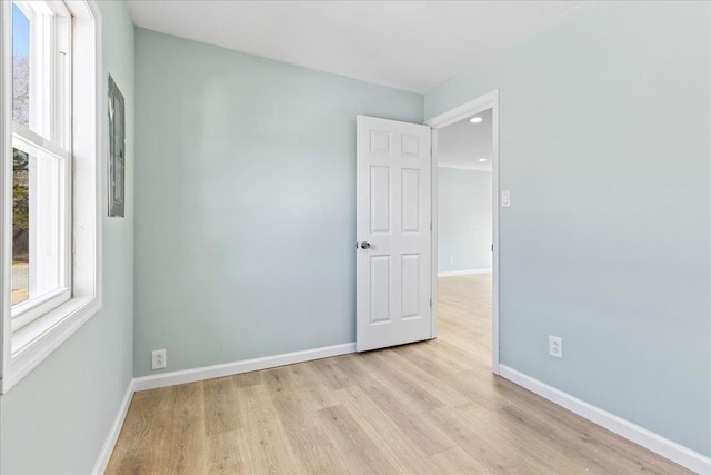 empty room featuring baseboards and wood finished floors