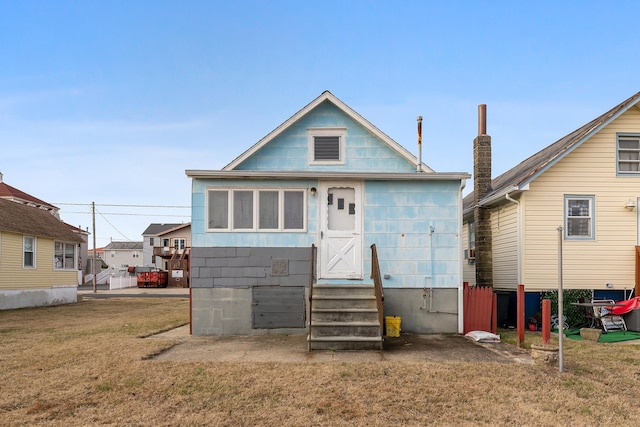 view of front of home with a front lawn and entry steps