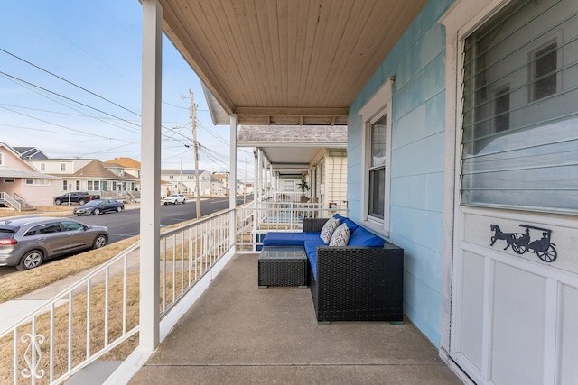 balcony with covered porch and a residential view