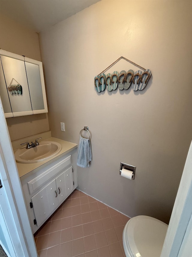half bath featuring toilet, tile patterned floors, and vanity